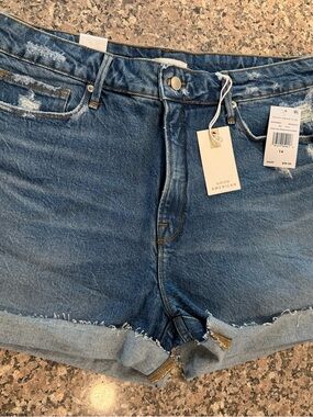 Good American Rolled-Hem Distressed Denim Shorts in Blue